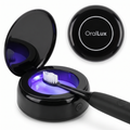 OralLux UV Drying and Sanitizing Dock in black, lid open with UV light on and a brush head inside